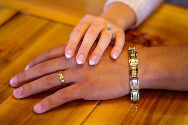 his and hers wedding bands holding hands